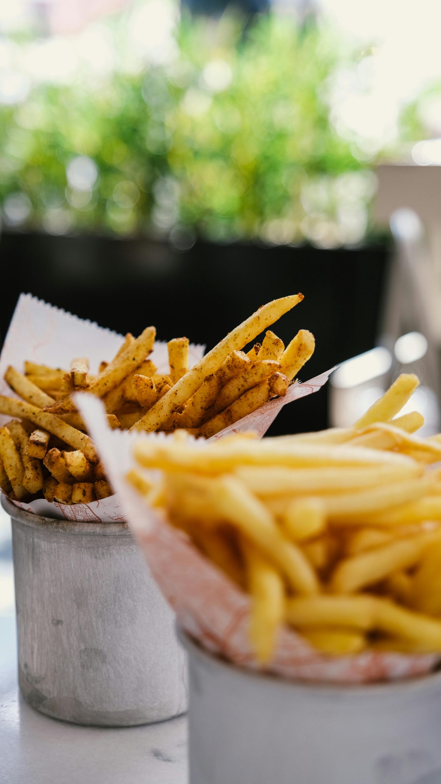 Appetizing crispy French fries served in rustic containers, perfect for fast food lovers.